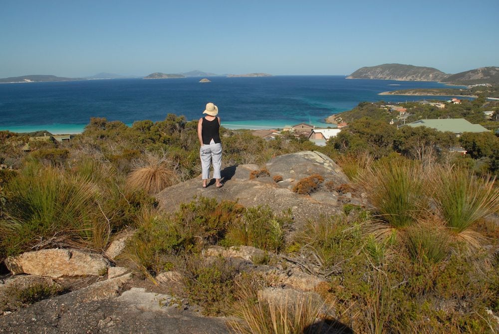 Landscape photo of a person looking out over the ocean at King George Sound | Featured Image for Centre Spotlight: Centre of Excellence in Natural Resource Management page by TERN.