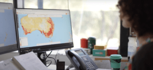 Photo of a person looking at a map of Australia on the computer | Featured Image for Centre Spotlight: The ANU Institute for Space Page by TERN.