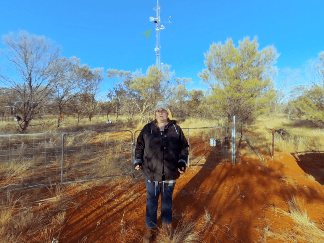 Photo of a lady standing in front of scientific equipment in the outback | Featured Image for Tour TERN's Outback Monitoring Supersite Page by TERN.