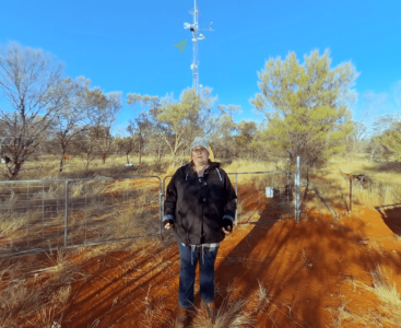 Photo of a lady standing in front of scientific equipment in the outback | Featured Image for Tour TERN's Outback Monitoring Supersite Page by TERN.
